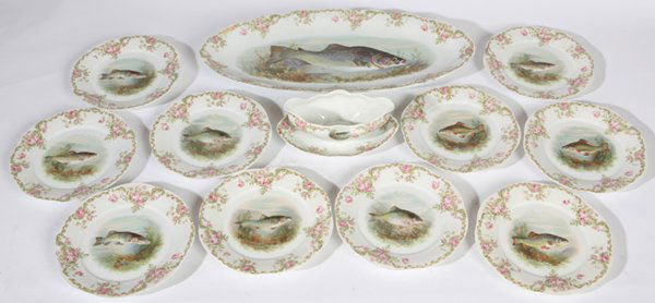 12 PIECE HANDPAINTED BAVARIAN PORCELAIN FISH SET: Hand painted with large lake trout and other species of fish, also rose border, marked "Mignon/2.5 & Co./Bavaria". Fine condition. Platter is 22 1/4" long, 10 plates 9", and gravy, 9".