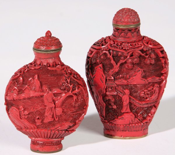 TWO CHINESE CINNABAR SNUFF BOTTLES: Both on brass bodies and signed on base, each with different garden scenes with figures. Both Fine condition. 2 1/2" and 3" h.