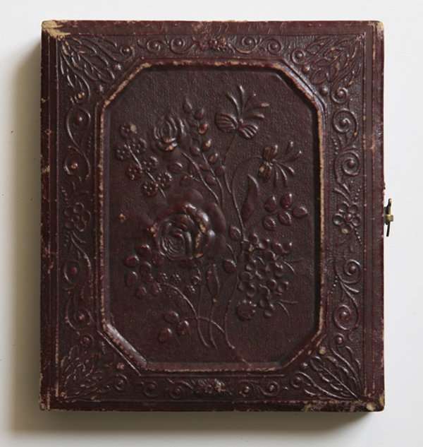 T. FARIS CINCINNATI TINTYPE OF WILLIE MCCALLUM: Red velvet matt of case is embossed “T. Faris Gallery N.W. Cor. 4th & Walt. Sts. Cincinnati” with a sixth plate tintype portrait of a young boy, mounted in floral embossed paper covered wood case.