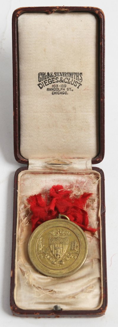SCARCE CASED BRONZE WM. MCKINLEY CHICAGO PARADE MEDAL: A fine 1.75” diameter bronze medal with front showing landscape with log cabin, farmer, miner, at sea coast with ships in background. Also an ink well and quill pen and an Indian Head coin, surround