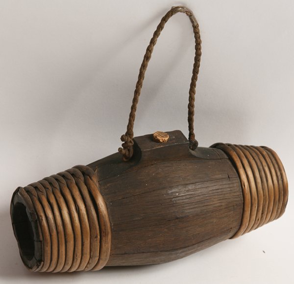 WAR OF 1812 RUM CANTEEN: Stave constructed with split cane wraps at ends, nice old patina, 9.5” long x circa 4” diameter.