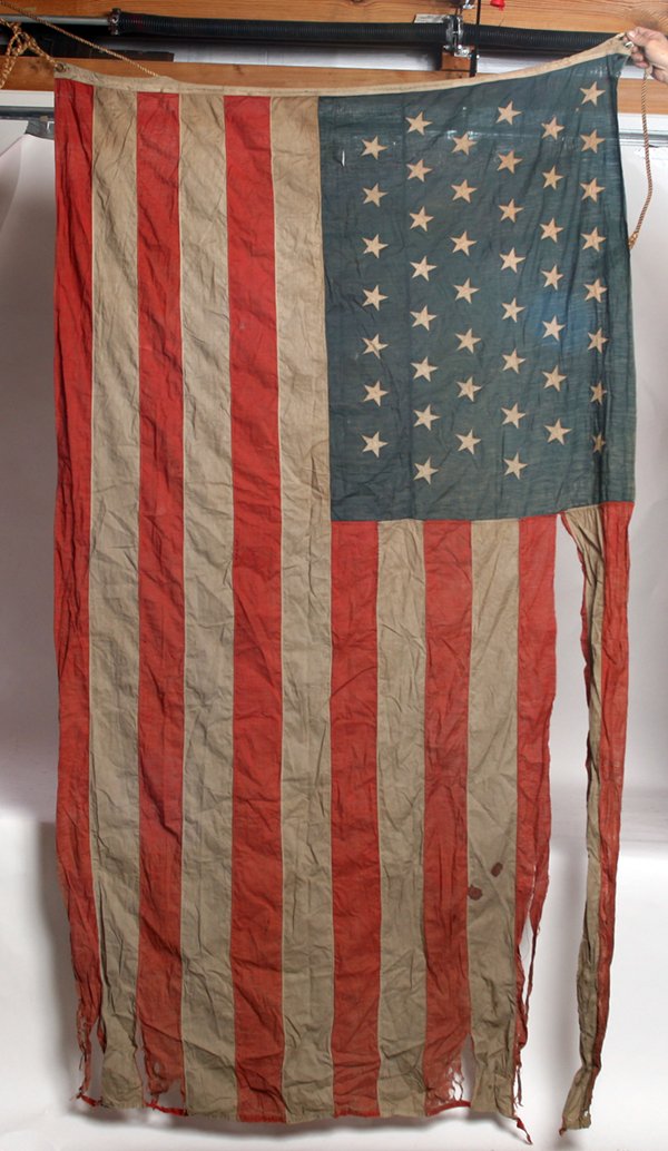 45 STAR SPANISH AMERICAN WAR SEWN U.S. FLAG W/ BLOOD ST: In cotton with sleeve type sewn canvas hoist with original hemp rope inside. Canton pattern is 8-7-8-7-8-7. 44” x 78”.