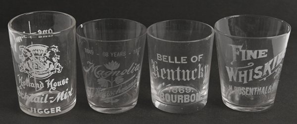 4 EARLY WHISKEY SHOT GLASSES: Early with enamel and etched lettering. 1) Fine whiskes, H. Rosenthal & Sons, one tiny chip, 2 1/4". 2) Magnolia by the Fleishmann Co., tiny chips, 2 3/4". 3) Belle of Kentucky, 1869 bourbon, tiny chi