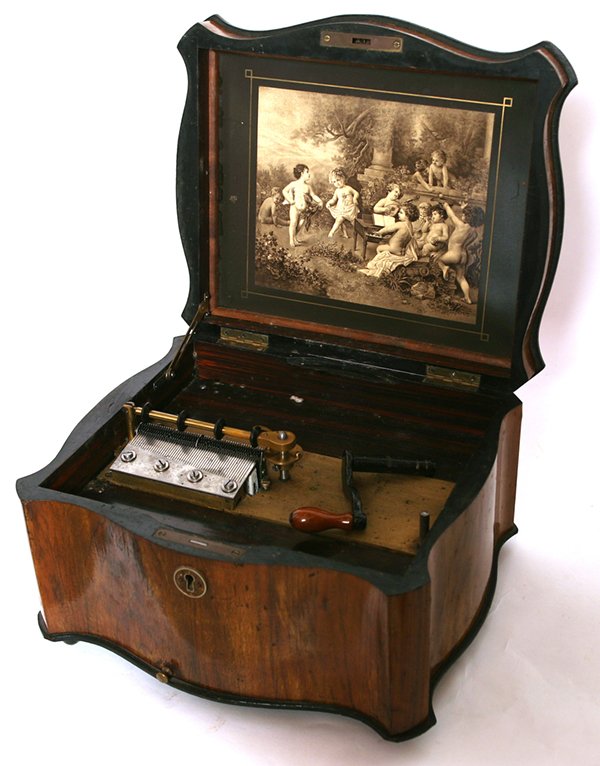POLYPHON 11" DISC MUSIC BOX: With original polyphon wooden shipping crate. Nice mahogany serpentine case with inlay. Single comb. Replaced crank. 5 Regina discs adjusted to play. 8" x 14 1/2" x 12 1/2"