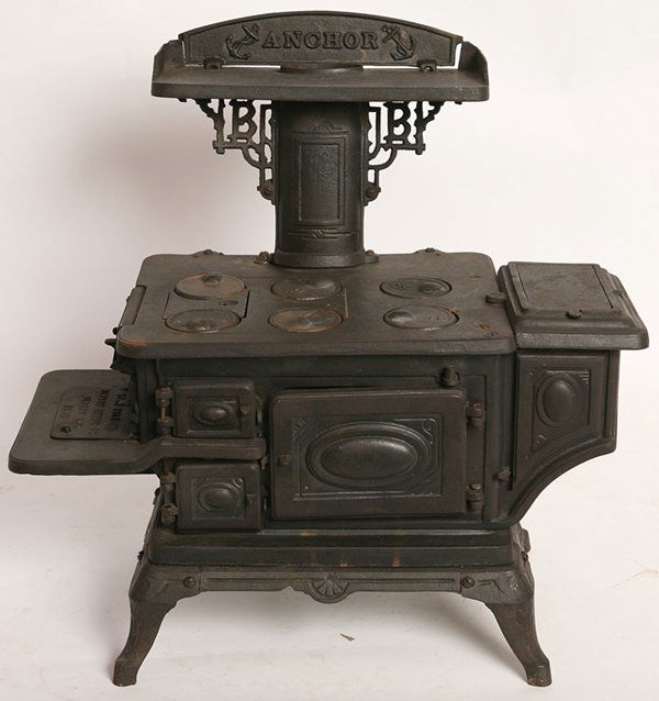 ANCHOR SALESMAN SAMPLE CAST IRON STOVE: Marked “Anchor” on warming shelf and “Home Yale Jr./Albany Stove Co./Albany N.Y./1890” on clean out. A wonderfully detailed stove with hot water tank on right side, 6 top removable burners, ov