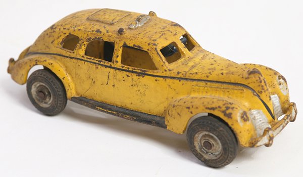 CAST IRON ARCADE YELLOW CAB CO. TOY: In original painted finish with “Yellow Cab Co.” on doors, black rubber wheels marked “Arcade Balloon 30 X5.25”, with cast-in name on underside “Arcade Made in U.S.A.”, with driver, 8” x