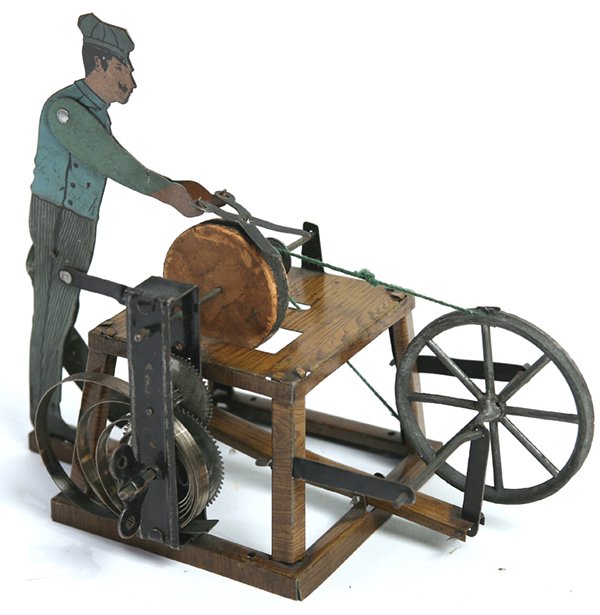 LITHOGRAPHED TIN GERMAN WINDUP TOY OF SCISSORS SHARPENE: Spring driven with chromolithographed tin part and wooden sharpening wheel with real emery surface, circa 1880’s, 3.25” x 6.75” x 5.5” high.