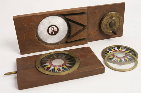 RARE LINCOLN MECHANICAL MAGIC LANTERN SLIDE, PLUS: Lot of two, includes a mechanical Kaleidoscope slide in maple frame with 5 dollar bill portrait of Abraham Lincoln in center, marked on side “Lincoln Chromagraph” with brass fittings, 4” x 11”