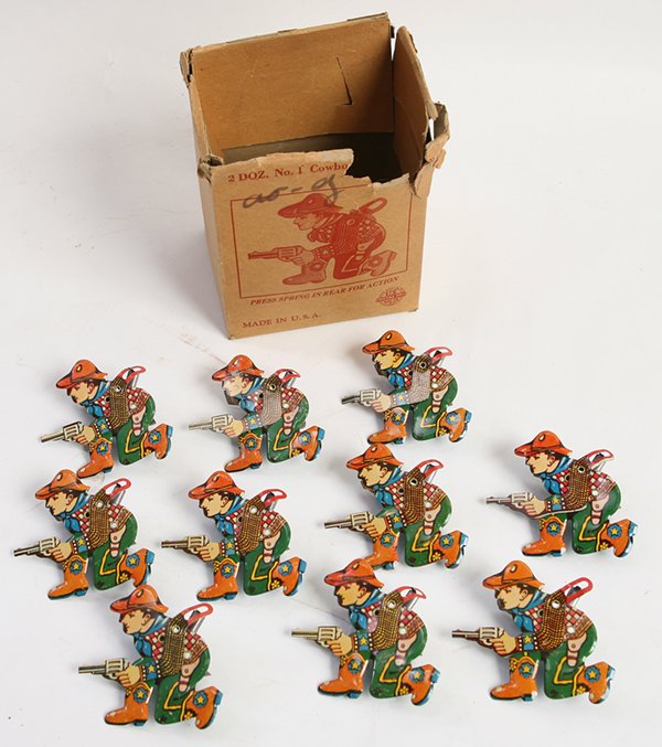 BOX OF METAL TOY CO. NO. 1 COWBOY TIN CLICKERS: The original illustrated card stock box had the above manufacturers mark, name of toy and other printed information and includes 10 of the original dozen lithographed tin clicking toys, when it is cli