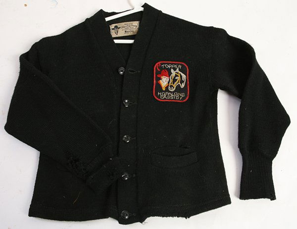 HOPALONG CASSIDY SWEATER JACKET: In black wool with original embroidered patch on left breast and printed label inside collar reading “Official Hopalong Cassidy 100% Wool…Barclay Knitwear Co. Inc.”, 16” long.