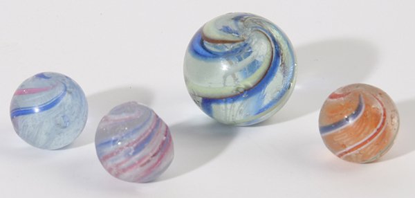 FOUR SWIRL MARBLES: Including one 1" with clear base and blue and white swirls, minor flakes. Plus two 1/2" swirls both with clear base and one with orange and one with white latticinio, good condition plus one small oni