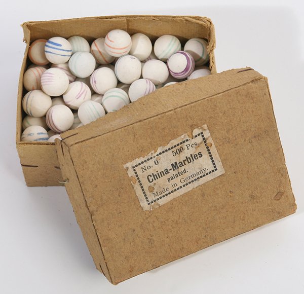 ORIGINAL BOX OF HAND MADE PAINTED CHINA MARBLES: In original card stock box with printed paper label on lid reading “No. 0 500 Pcs China-Marbles painted Made in Germany”. Box is 2.75” x 3.75” x 2” high, and nearly full.