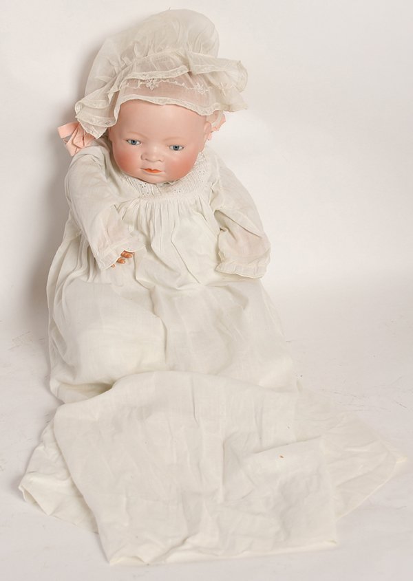 GRACE PUTNAM BYE-LO BISQUE HEAD BABY DOLL: Marked on back of head “Copr. By Grace S. Putnam” with sleep blue glass eyes, closed mouth, on cloth body with crier box, original cello hand, period white gown, with lace bonnet, head circumferen