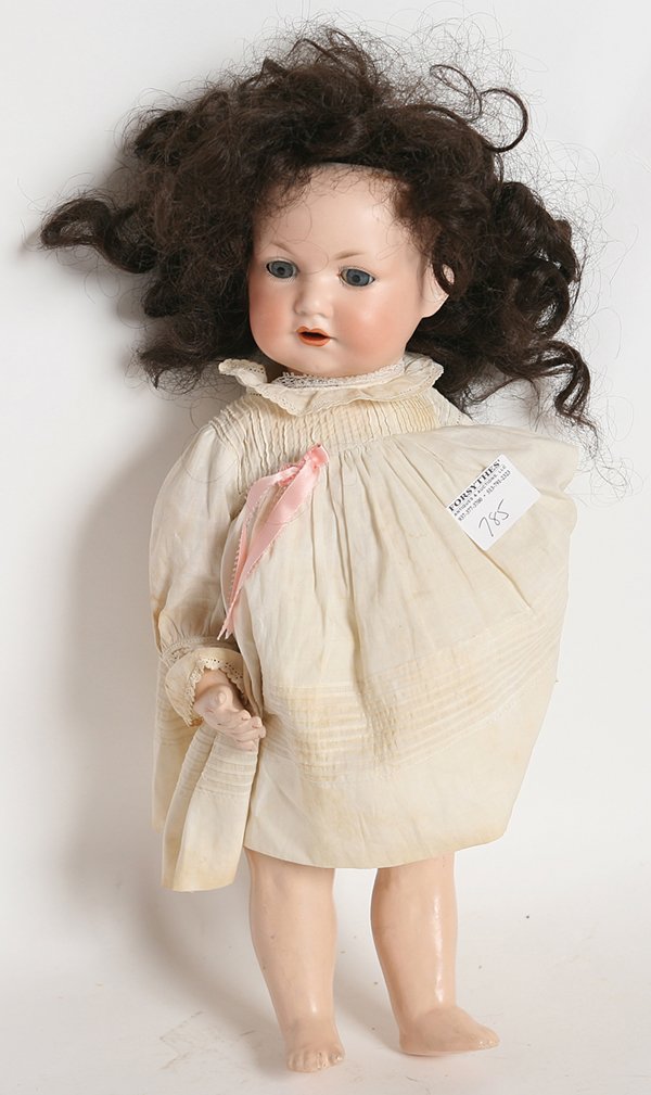 A.M. 971 BISQUE CHARACTER BABY DOLL: Socket head marked on back of head “Germany 971 AQ. 5 M. D.R.G.M. 267/1” with fixed blue glass eyes, open mouth, 5 piece composition body, newer brown wig in period white outfit with undergarments