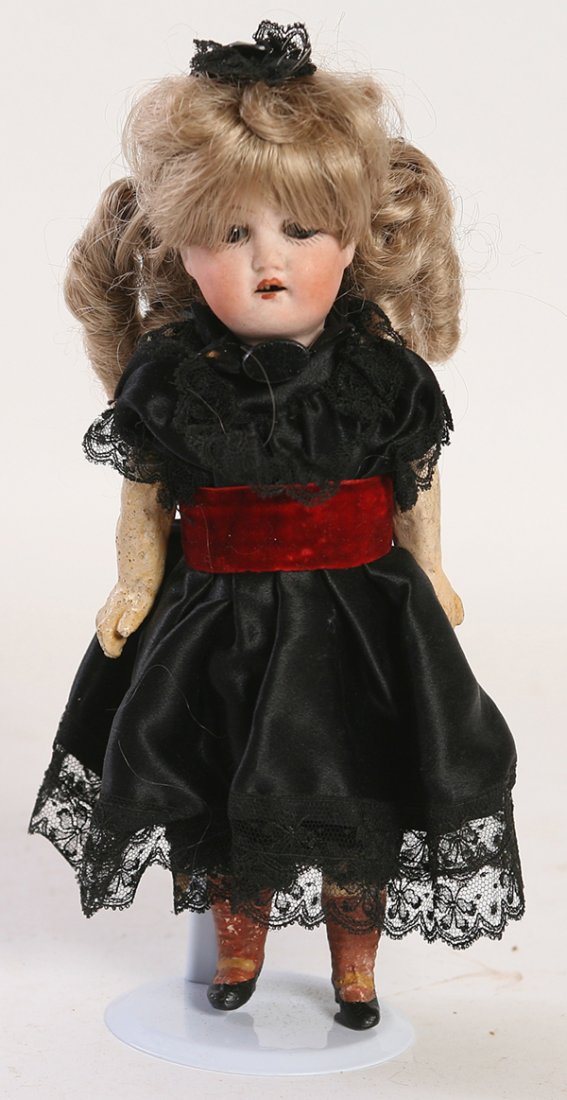 E&S GERMAN BISQUE CHILD DOLL: Socket head marked on back of head “E&S 15/0” with fixed brown glass eyes, open mouth, older blond wig, 5 piece composition body with molded and painted shoes and stockings, in older black dress a