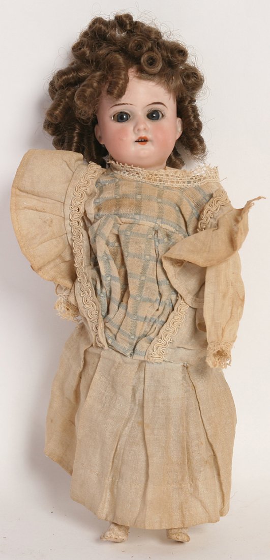 A.M. 390 BISQUE CHILD DOLL: Socket head marked on back of head “Made in Germany 390 A. 4/0 M.” with sleep blue glass eyes, newer brown wig, 5 piece composition body in original blue and white dress, 12” tall.