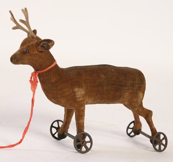 EARLY STEIFF FELT DEER ON WHEELS: Early 20th Century deer pull toy on iron wheels. Unmarked. 5" high x 8" wide.