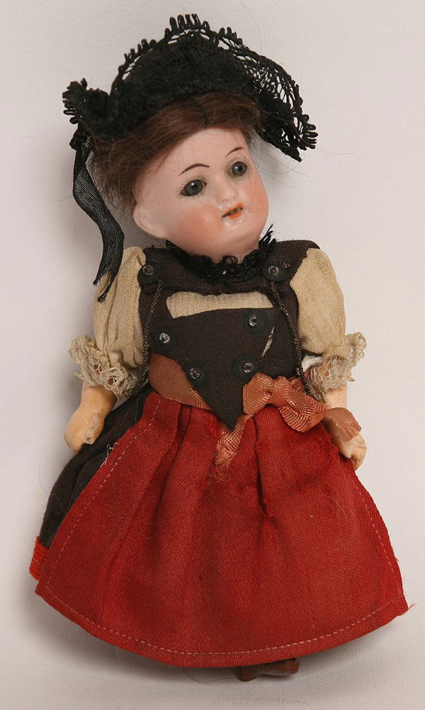 GOEBEL PEASANT GIRL BISQUE DOLL: ocket head mMarked on back of head with Goebel crown mark over “121.16” with fixed gray glass eyes, open mouth, original brown wig on 5 piece composition body with molded & painted shoes and stock
