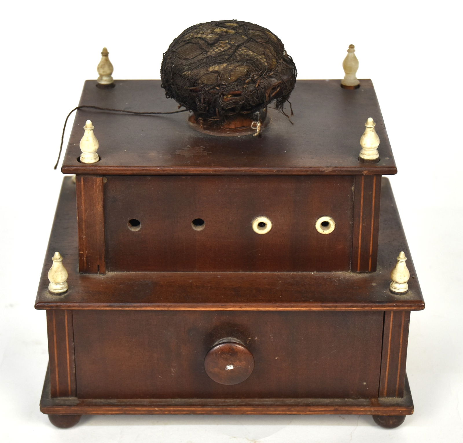 Shaker Sewing Box: Mahogany with satinwood line inlay, stepped with drawer in base with turned knob, upper section with bone eyelets for eight spools of thread, turned bone finials and pin cushion top, ball feet in orig