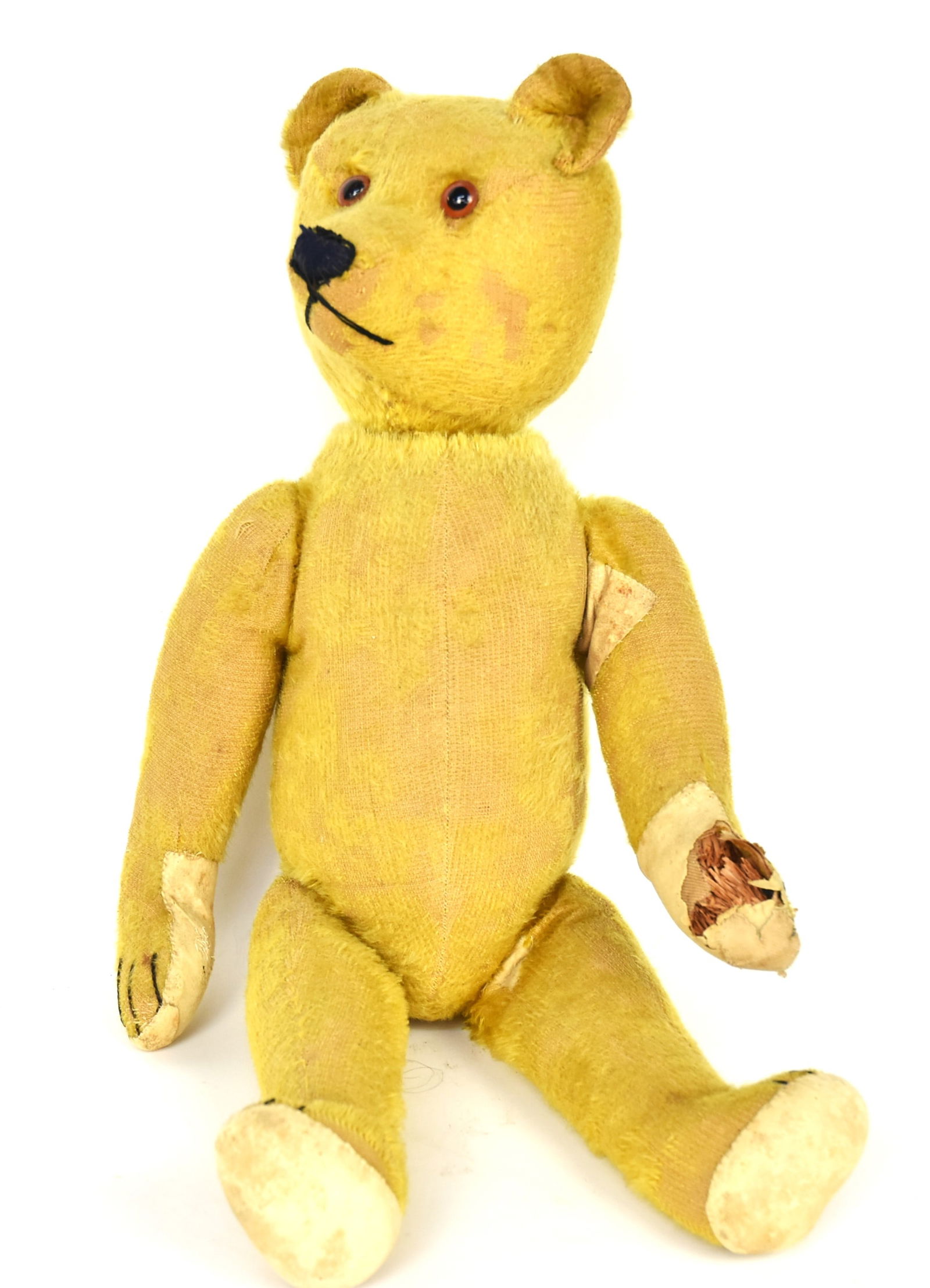 Early Blonde Schuco Turn Head Teddy Bear: Mohair covered with turn head with growler excelsior stuffed with black tread sewn mouth, nose & claws tan felt pads at feet, jointed legs with tail that operates turning head (working), 20" tall. Con