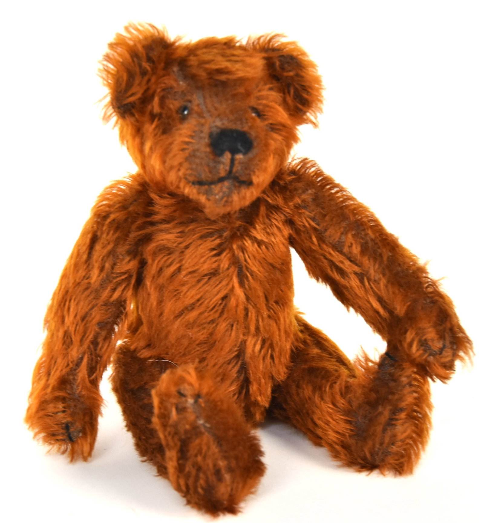 Red Mohair Teddy Bear: Excelsior stuffed with turn head, glass eyes, back thread sewn mouth, nose & claws, jointed legs, 9" tall. Condition slight wear VG+.