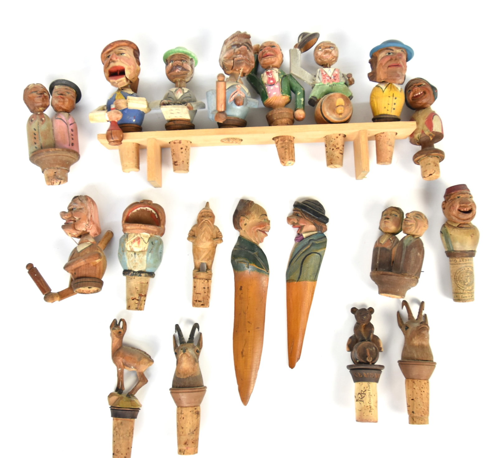 Italian Carved & Painted Wood Figura Stoppers Plus: Lot of 19, most including nine mechanical comic cork end stoppers, five of which are on wood stand, two of which are double figures, circa 4-5" high; plus tooth pick with open mouth comic man, 4.5" hi