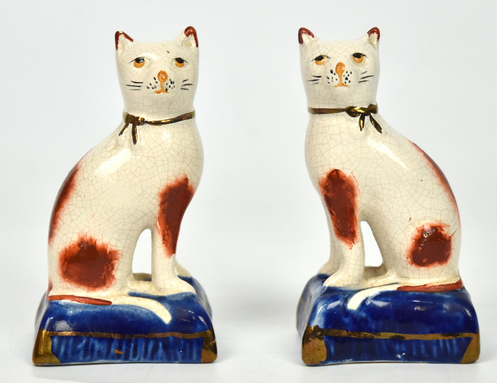 Pair of Old Staffordshire Cats: 4 1/4" H x 2 1/4" One very small flake on one ear; otherwise good condition.