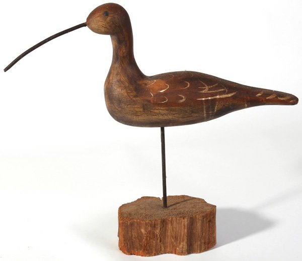 SHORE BIRD DECOY BY JIM SLACK: With painted feather details and brass tack eyes on drift wood base, signed on base Jim Slack, 19” long x 18” high.