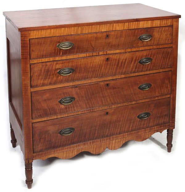 TIGER MAPLE SHERATON CHEST: Circa 1825 four drawer chest with tiger maple front and cherry case. Nice high turned feet with cutout apron and cutout sides. Dovetailed construction. 43" high x 40" wide x 20 1/2" deep.