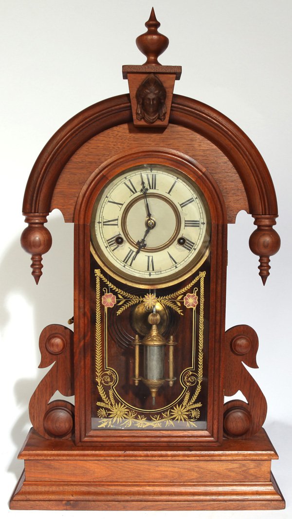 NEW HAVEN ELBE KITCHEN CLOCK: In walnut case with Minerva head in pediment and turned drops, original gilt painted geometric tablet, painted tin dial with brass surrounds, brass time & strike spring driven movement with original p