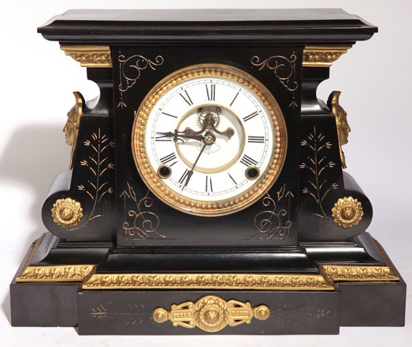 ORMOLU MOUNTED AMERICAN IRON CLOCK: Unknown maker with bronze mounts, including Minerva heads at sides, porcelain dial with open escapement, brass time & strike spring driven movement with original pendulum. Old New York printed label o