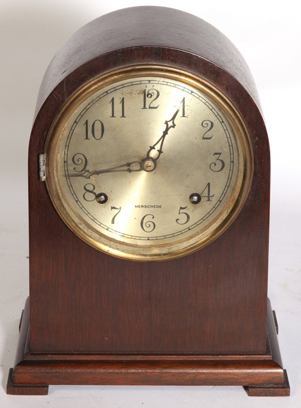 HERSCHEDE DOMED MANTLE CLOCK: In mahogany case with silvered dial with marked “Herschede”, brass time & strike 8-day spring driven movement stamped “Herschede/Cincinnati” with crown above, with original pendulum and label 