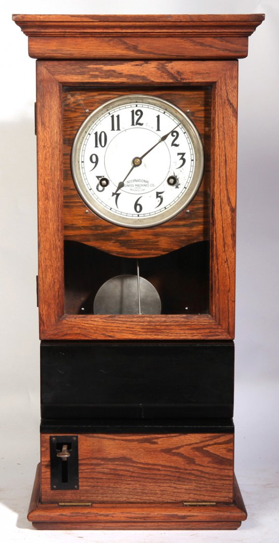 IBM TIME CLOCK: In hanging oak case with painted steel dial marked “International/Business Machines Co.,/Limited/Toronto, Ont.” With punch card time recorder and both keys, 31.75 x 15 x 9.25”.