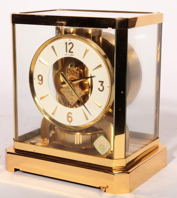 LECOULTRE ATMOS CLOCK: With enameled brass dial marked “LeCoultre.” Top of brass time only works marked ”LeCoultre Atmos 344658”. In original lacquered finish, with printed paper label on front of glass cover and ma