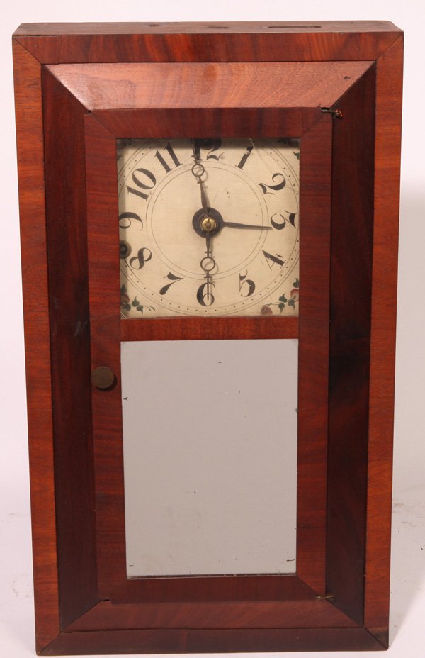 SCARCE SILAS HOADLEY OGEE CLOCK: In mahogany case with mirrored lower tablet, nice small size, painted wood dial, wooden time & strike weight driven movement and original printed paper label on interior reading in part “S. Hoadley/