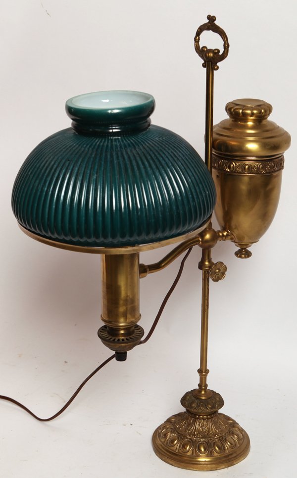SINGLE STUDENT LAMP WITH EMBOSSING: Fine student lamp with embossed ring around tank holder and ornate embossed base. Thumb wheel marked the Belgium lamp. Six ribbed green cased shade. 26" high. 9 3/4" shade.