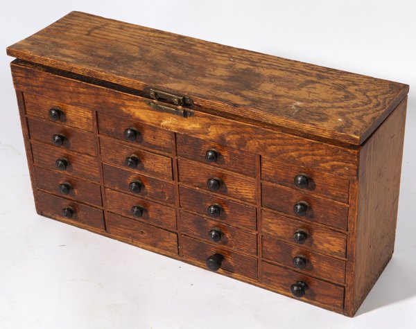 WATCHMAKERS OAK SET OF DRAWERS: With hinged lid opening to divided compartment over 4 rows of 5 drawers with original ebonized turned wood knobs in old original varnish finish with poplar secondary wood, 4.75 x 16 x 8.5”high.