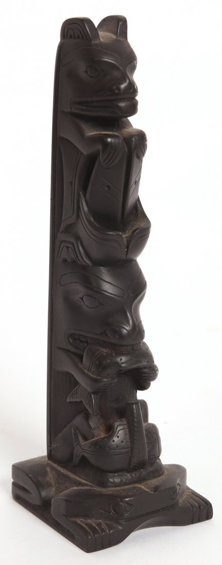 FINE ARGILLITE TOTEM POLE: With frog base with bear eating salmon with second held below and beaver atop, beautifully carved, 8” high.