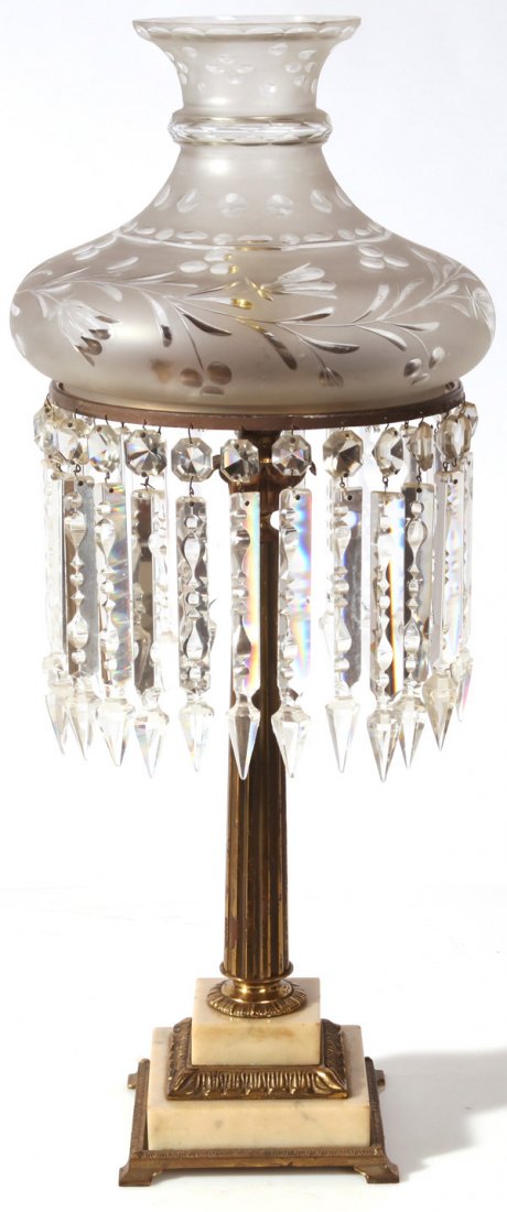 EARLY BRONZE SINUMBRA LAMP: Frosted and cut glass sinumbra shade has a bell form with rolled top rim12”diameter with cut glass hanging prisms; tapered fluted column stem has flower form capital and acanthus leaf plinth on tier