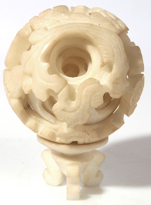 CHINESE MYSTERY BALL: In white alabaster with stand, six layers with dragon carving, 4.5”diameter, 6.5”high on stand.