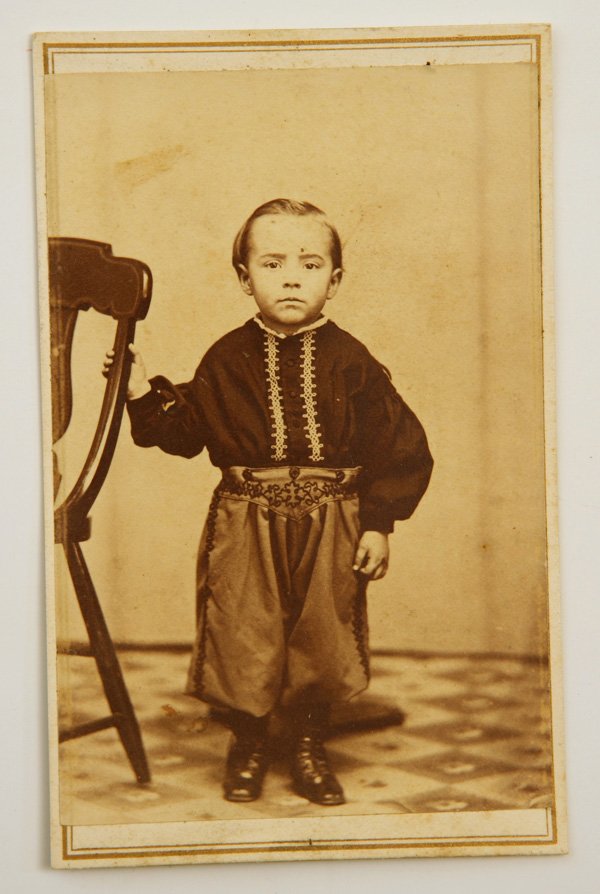 ALBUMEN CDV OF CHILD IN ZOUAVE UNIFORM: An adorable photo of a circa 3 year old boy dressed in an elaborately embroidered shirt and pants of a Zouave soldier and wearing a fez type hat (just visible) with imprint of W. Granger, Ashley, Ohio