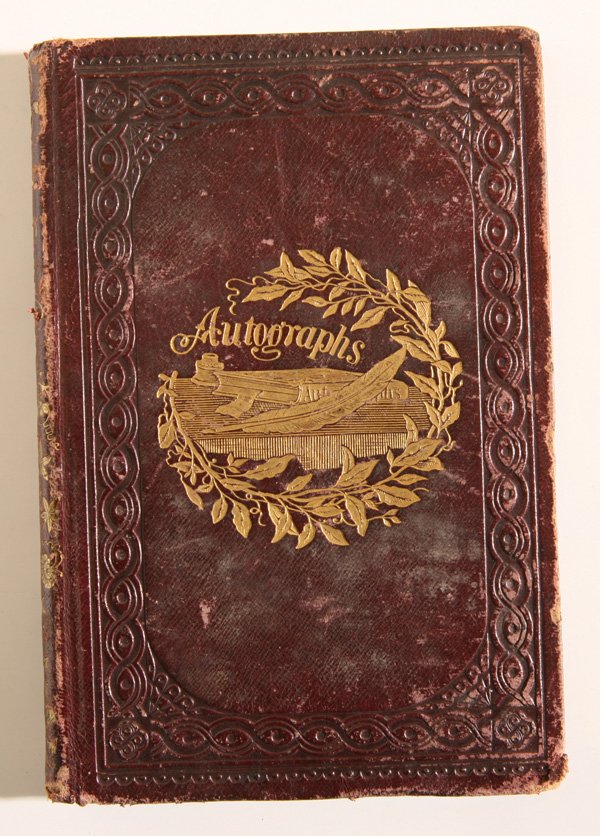 CIVIL WAR ERA AUTOGRAPH BOOK FROM GWYNEDD MERCY ACADEMY: A small 8vo in embossed brown calf boards with gilt decoration on front cover of an autograph book resting on a table with quill pen and ink bottle and “Autographs” above. This book has plain unli