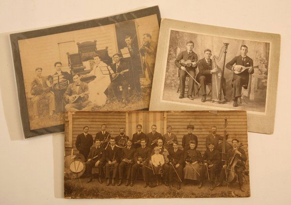 GROUP OF EARLY PHOTOS OF MUSICIANS: Lot of 3, all circa 1900-20, including a 4.5” x 9.75” silver print of 18 members of a band, instruments include several violins, cello, base, 3 coronets, French horn, trombone, drums, flute and ot