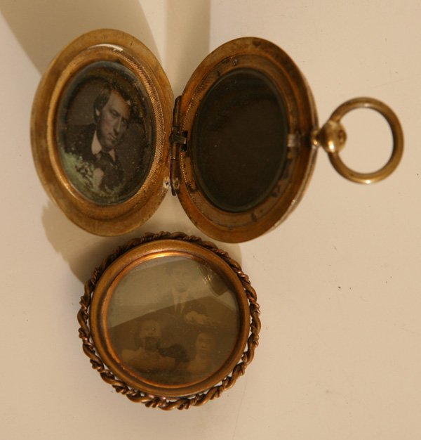 TWO DAGUERREIAN PHOTO LOCKETS: Includes a pocket watch type in worn gold plate, 1.7” diameter with push button release revealing a daguerreotype portrait of a middle aged man, second window with woven fabric of hair, undoubtedly 