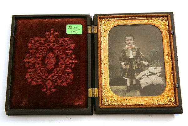 QUARTER PLATE AMBROTYPE PHOTO OF LITTLE BOY IN KILT: Lovely portrait of a young boy dressed in Scottish kilt with tan-o-shan and cloak resting on sofa to right, with fine hand tinting, mounted in a black Union Cupid and stag thermal plastic case (Gutta 