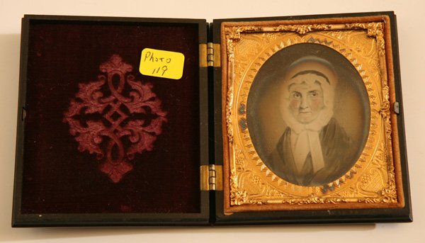 AMBROTYPE PHOTO OF FOLK ART PAINTING: Of an elderly lady in white bonnet, housed in a black Union scroll work case