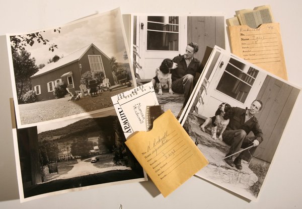 PHOTOGRAPHS OF NORMAN ROCKWELL: Lot of 20, all circa 1948-49, taken in W. Arlington, Vermont, including four 8 x 10” silver prints showing him seated on the back steps of his home with his dog, with cane and glasses in left hand (