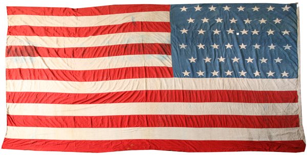 HUGE 46 STAR U.S. GARRISON FLAG: Machine sewn linen with stars sewn to canton in 8-7-8-8-7-8 pattern, canvas hoist with two brass grommets, circa 1907-12, 106 x 166”.