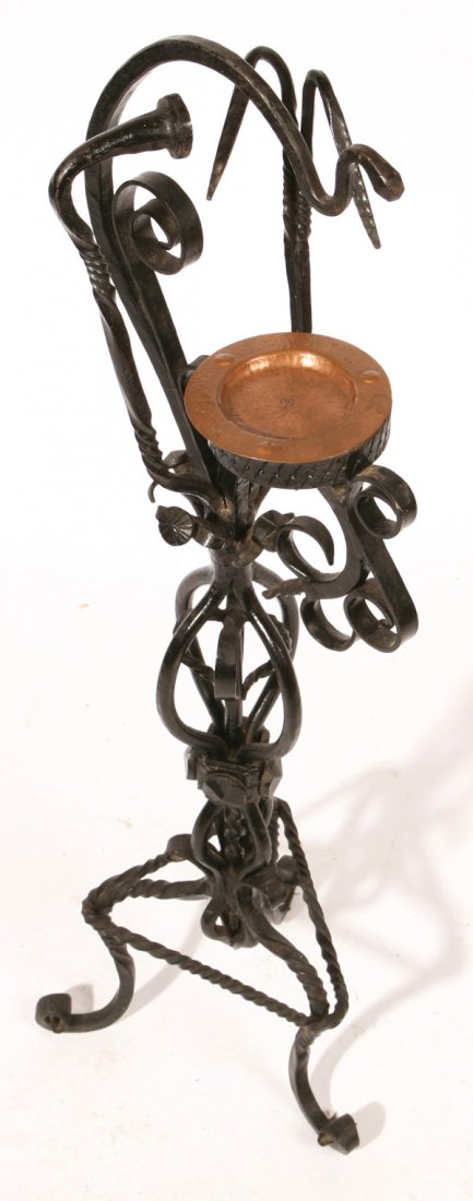 MARKED ROYCROFT WROUGHT IRON ASH STAND: With marked Roycroft 5”diameter hammered copper ash tray. This very ornate stand has rattail spirals and poppy head terminals, triangular base with three scrolled feet, all hand wrought iron in orig