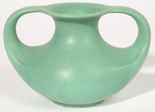 TECO POTTERY DOUBLE HANDLED VASE: Green matt glaze . Stamped "Teco" mark and numbered "297". 5 1/2" high x 8 1/2: wide.